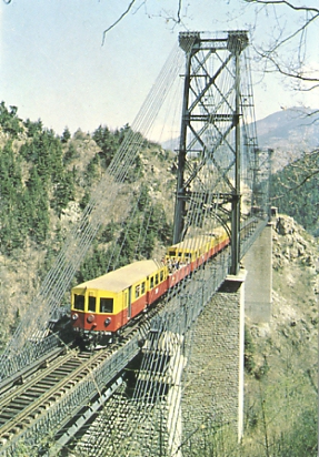 Le petit train jaune sur le pont Gisclard en Cerdagne. Le pont est construit de 1905 à 1908 par l’entreprise de Ferdinand Arnodin, suivant un dessin conçu en 1896 par le commandant du Génie Albert Gisclard. Ce dernier décéda le 31 octobre 1909 dans un accident ferroviaire, au cours d’essais de charge, qui coûta la vie à cinq autres personnes. C’est ainsi que le pont portera le nom de son concepteur. Il est en pente et c’est le seul pont suspendu ferroviaire encore en service en France en 2009.